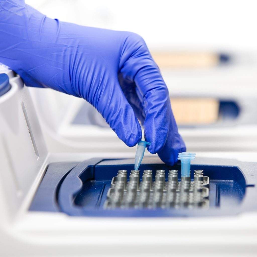 Lab Tech inserting sample for Multiplex PCR Listeria Detection System
