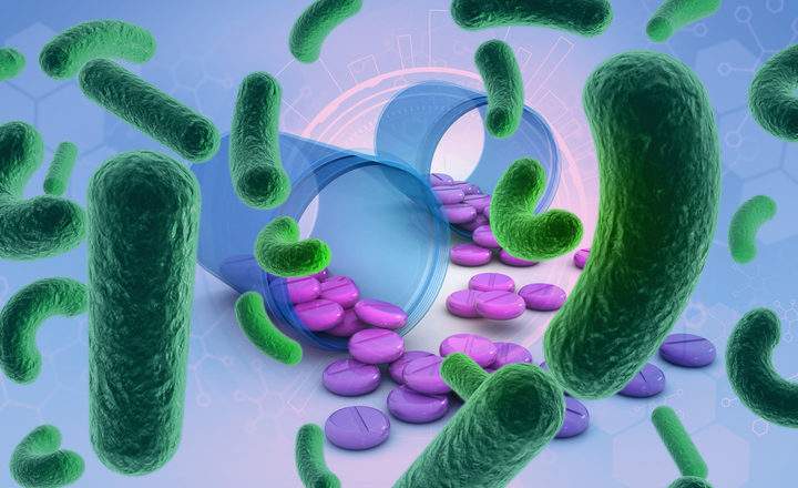 Computer generated bacteria in front of generic medicine pills.